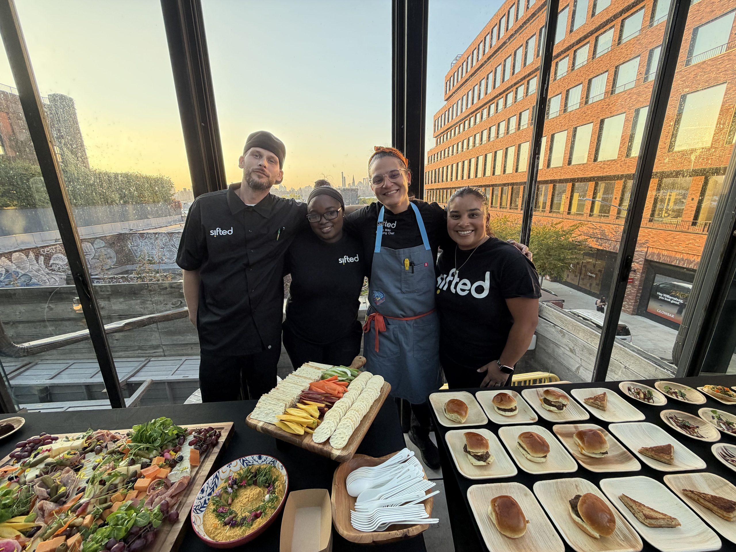 Sifted team standing with a corporate catering setup